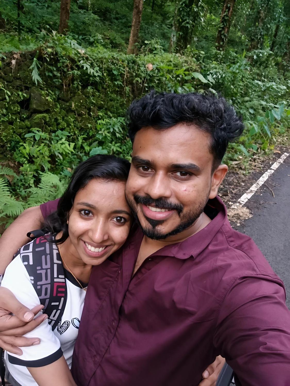 A candid selfie of Joji and Bismi on a forest road